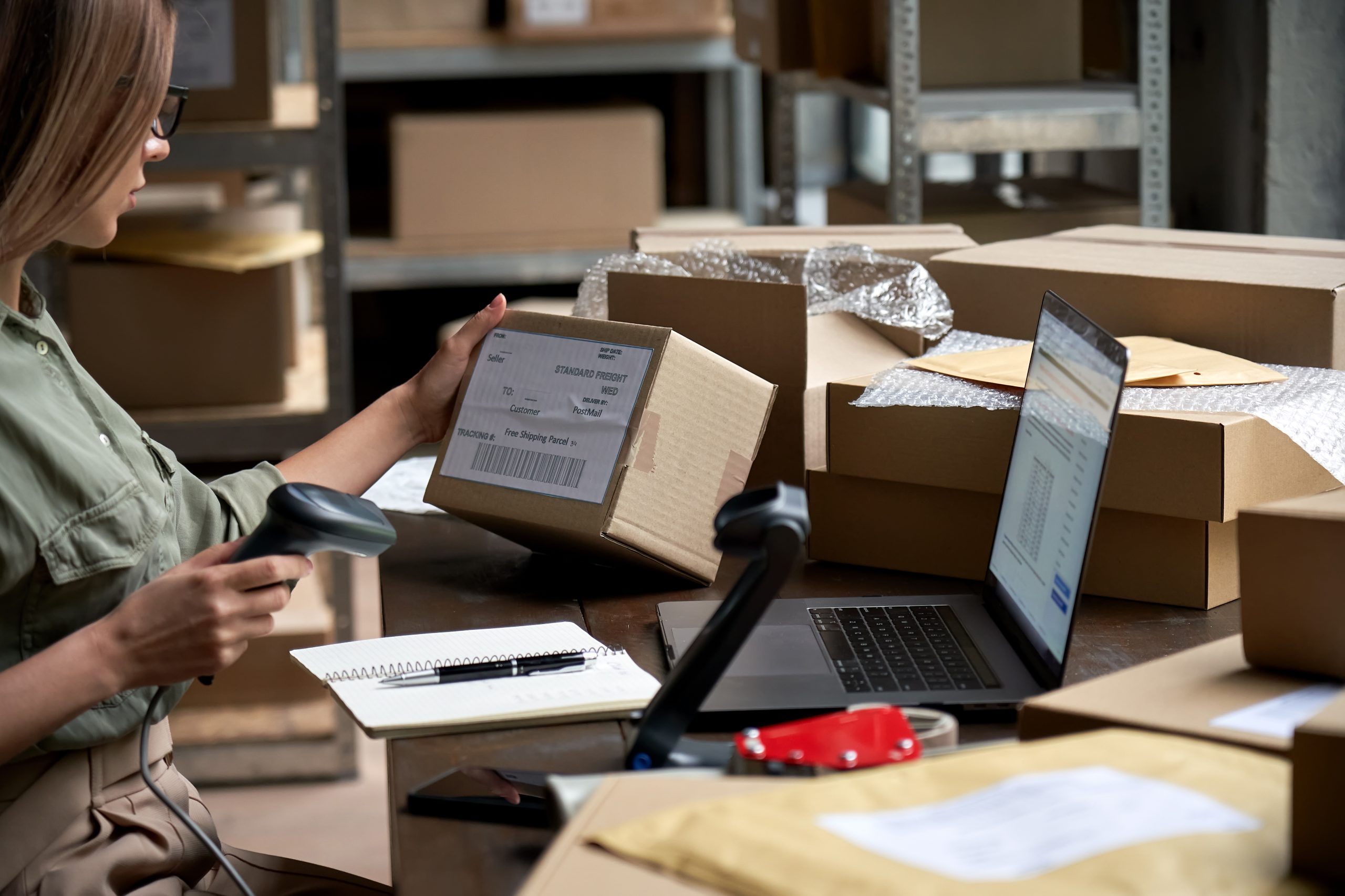 Female,Seller,Worker,Online,Store,Holding,Scanner,Scanning,Parcel,Barcode